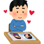 アイドル写真を眺める男