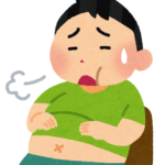 満腹で苦しそうな男性